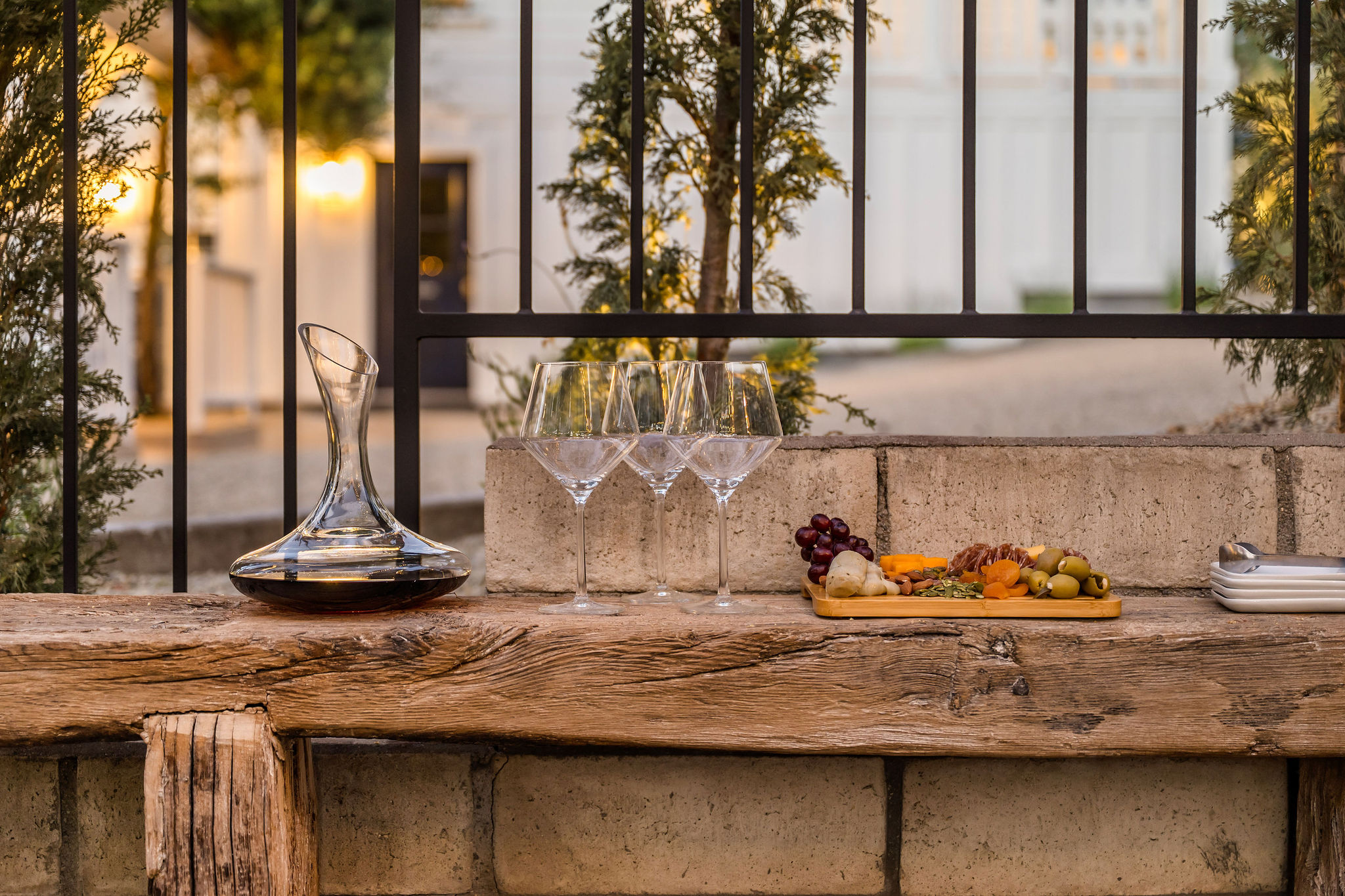 The Polo House Aperitif, wine and charcuterie on a rustic ledge at dusk